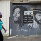 A woman walks past a ‘We Must Stop Killing Each Other’ sign on June 23, 2016, in Baltimore. (Mark Makela/Getty Images)
